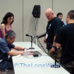 Noburo Ishiguro Signs a Poster